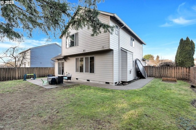 back of property with a patio area and a yard