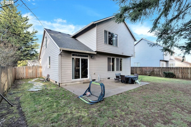 back of house featuring a lawn and a patio