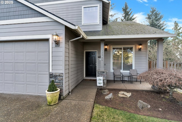 property entrance with covered porch and a garage