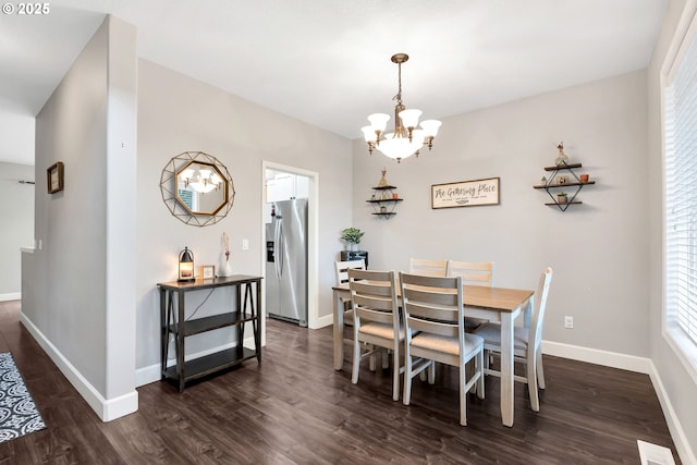 dining room with a chandelier and dark wood-type flooring