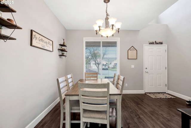 dining area featuring dark hardwood / wood-style flooring and an inviting chandelier