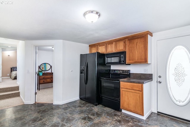 4976 NE K Ave, Neotsu, OR 97364 - kitchen with black appliances, dark countertops, baseboards, and brown cabinets