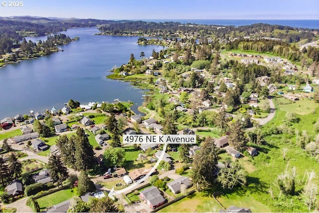 4976 NE K Ave, Neotsu, OR 97364 - aerial view of property and surrounding area featuring a large body of water and nearby suburban area