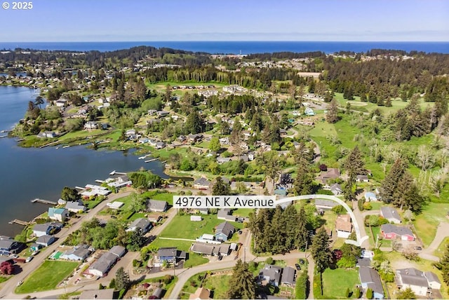 4976 NE K Ave, Neotsu, OR 97364 - aerial view of property and surrounding area with a nearby body of water and nearby suburban area