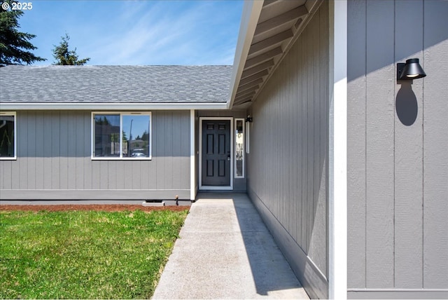 property entrance with a shingled roof