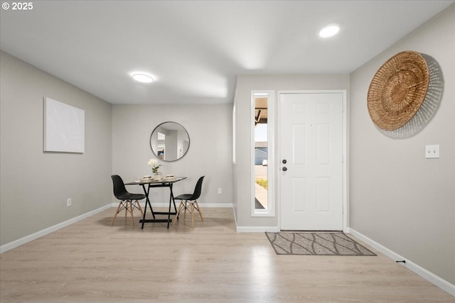entryway featuring wood finished floors, baseboards, and recessed lighting