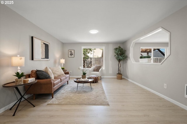 living room featuring baseboards and wood finished floors