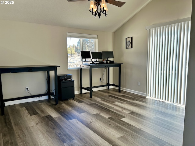 office space with vaulted ceiling, wood finished floors, a ceiling fan, and baseboards