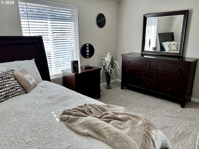 carpeted bedroom featuring baseboards