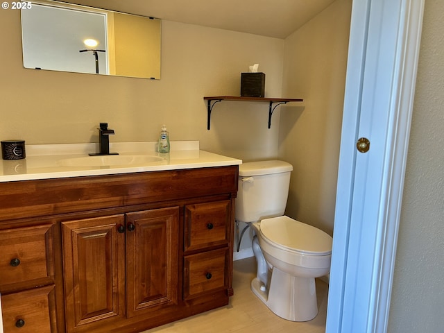 bathroom with toilet and vanity