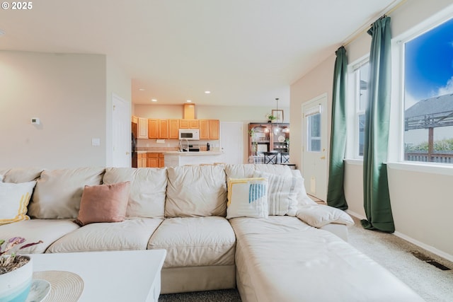 311 W Jadon Dr, Lebanon, OR 97355 - living room with light colored carpet, baseboards, and recessed lighting
