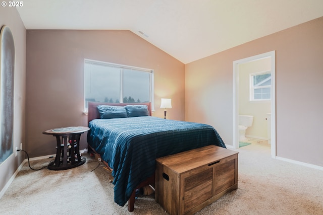 311 W Jadon Dr, Lebanon, OR 97355 - carpeted bedroom with vaulted ceiling, baseboards, and ensuite bathroom