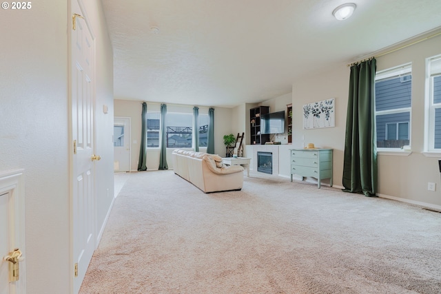 311 W Jadon Dr, Lebanon, OR 97355 - carpeted living room featuring baseboards and a glass covered fireplace