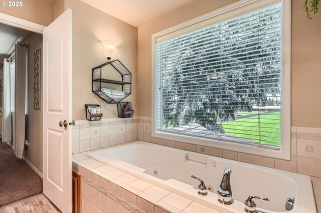 full bath with wood finished floors and a whirlpool tub