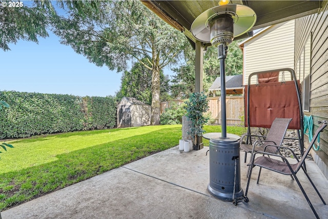 view of patio with a storage unit, a fenced backyard, and an outdoor structure