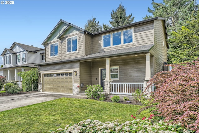 craftsman-style house featuring a front yard, covered porch, board and batten siding, concrete driveway, and an attached garage