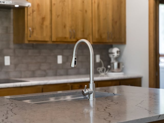 room details with brown cabinetry and a sink