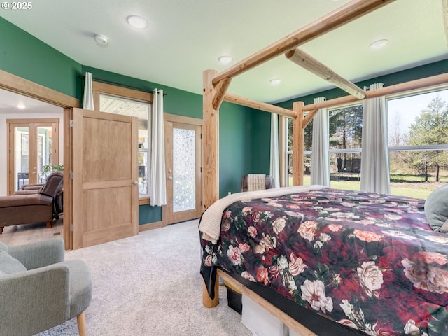 carpeted bedroom with recessed lighting, multiple windows, and french doors