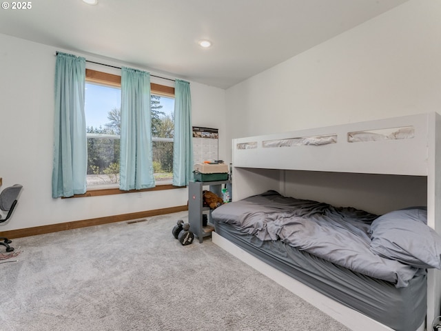 carpeted bedroom featuring recessed lighting, visible vents, and baseboards