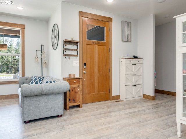 entryway with recessed lighting, baseboards, and light wood-style flooring