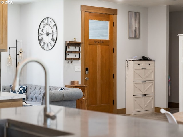 foyer featuring baseboards