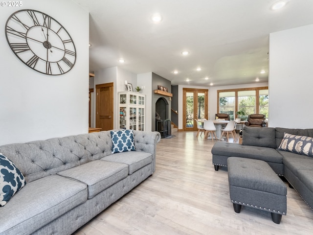 living area with recessed lighting and light wood finished floors