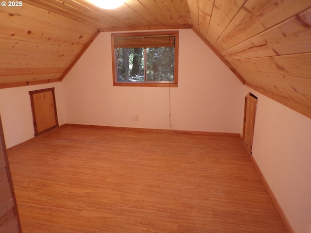 additional living space with light wood-style floors, lofted ceiling, wood ceiling, and baseboards