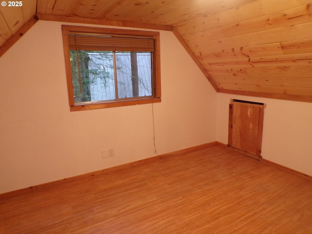 bonus room with vaulted ceiling, light wood-type flooring, and wood ceiling