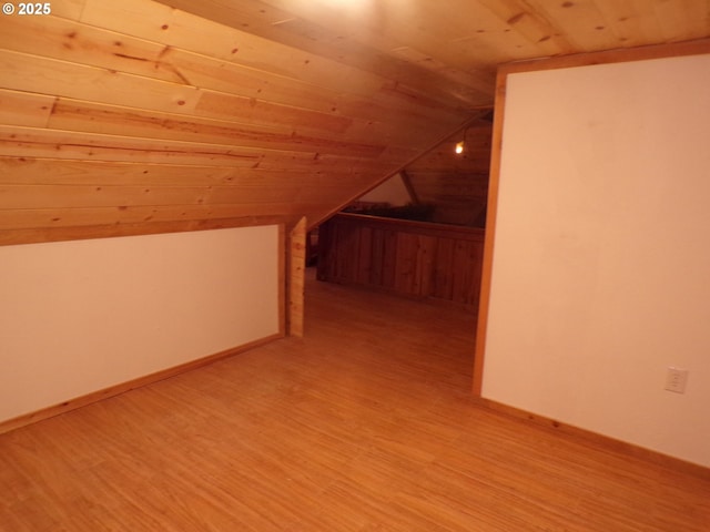 bonus room featuring vaulted ceiling, light wood-type flooring, wood ceiling, and baseboards