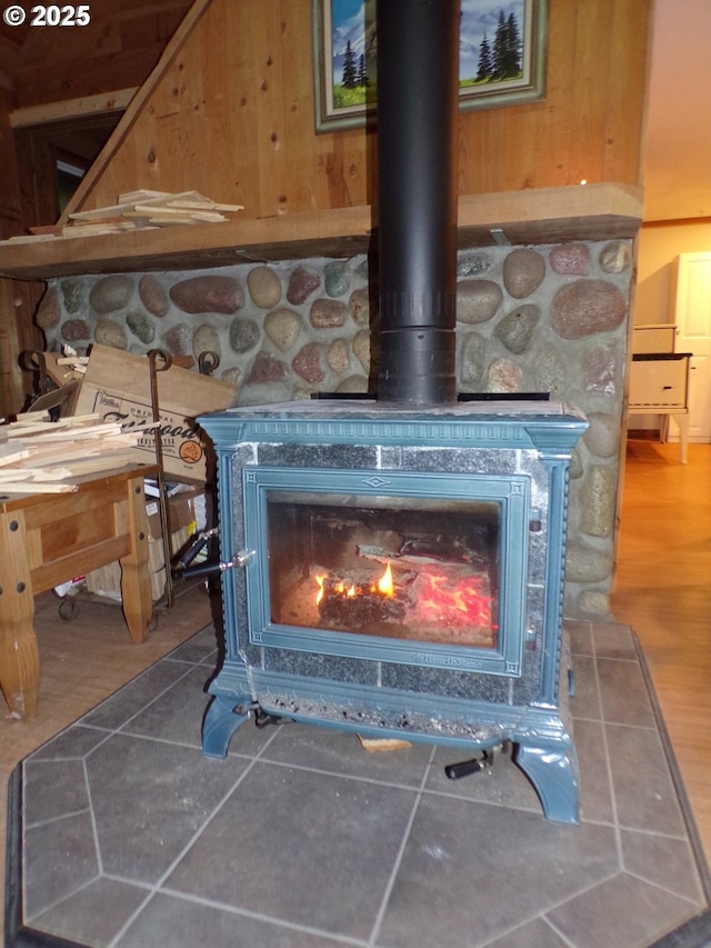 details with a wood stove and wood finished floors