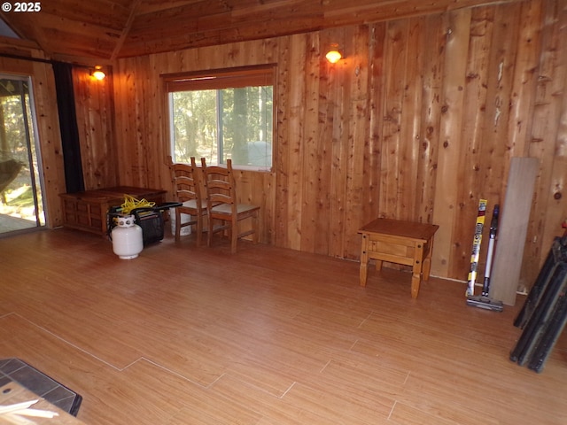 interior space featuring wood finished floors, visible vents, and wooden walls