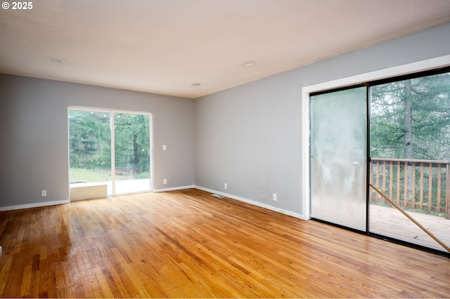 empty room with light hardwood / wood-style flooring