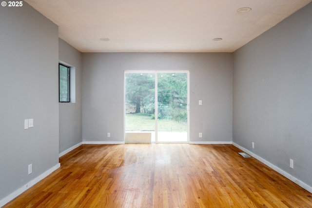 spare room featuring light wood-type flooring