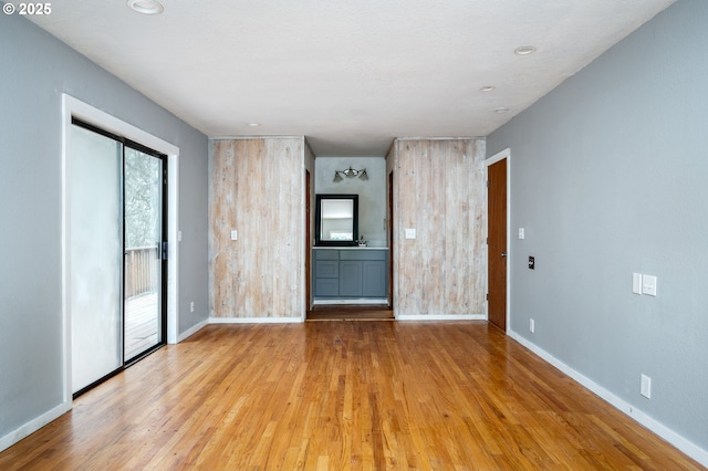 empty room with sink and light wood-type flooring