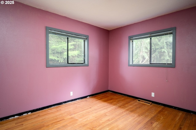 unfurnished room with hardwood / wood-style floors