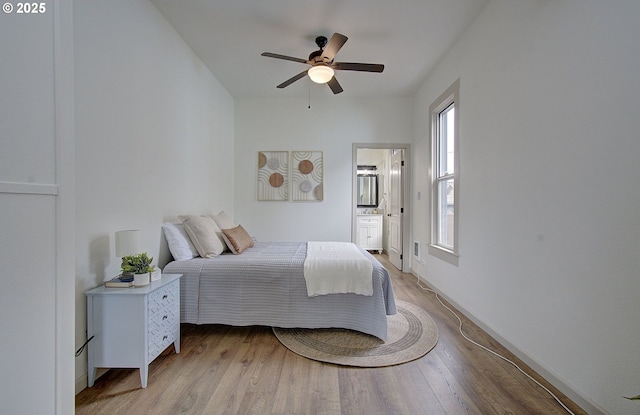 126 NE Garfield St, Camas, WA 98607 - bedroom with light wood-style flooring, ensuite bath, and a ceiling fan
