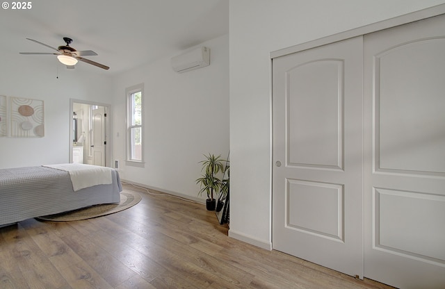 126 NE Garfield St, Camas, WA 98607 - bedroom featuring an AC wall unit, light wood-style floors, and a ceiling fan
