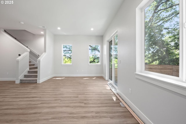 9258 SW Waverly Dr, Tigard, OR 97224 - unfurnished living room with plenty of natural light, stairway, light wood-type flooring, baseboards, and recessed lighting