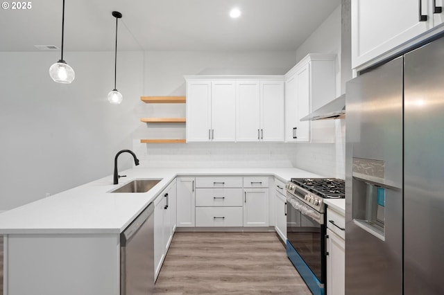 9258 SW Waverly Dr, Tigard, OR 97224 - kitchen with appliances with stainless steel finishes, a sink, open shelves, light wood finished floors, and light countertops