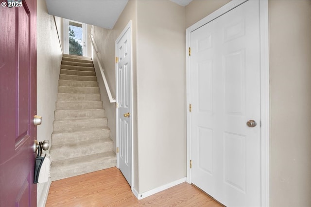 stairway with baseboards and wood finished floors