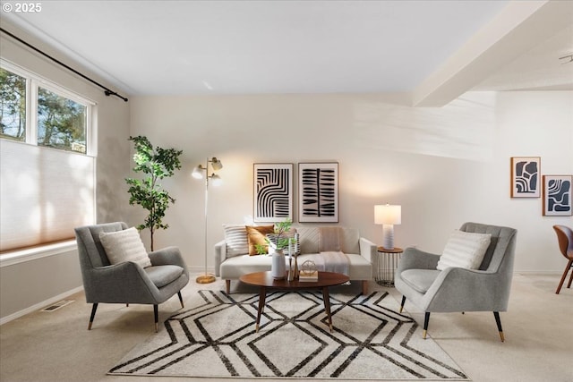 living room with beam ceiling, carpet, visible vents, and baseboards