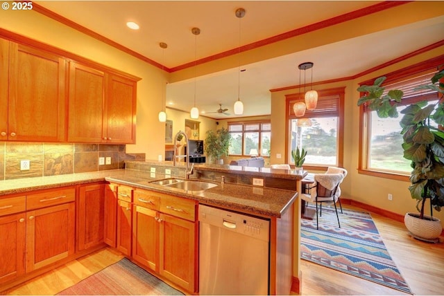 kitchen featuring sink, light wood-type flooring, dishwasher, and kitchen peninsula