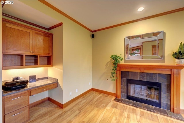 living room with a fireplace, light wood-type flooring, and ornamental molding