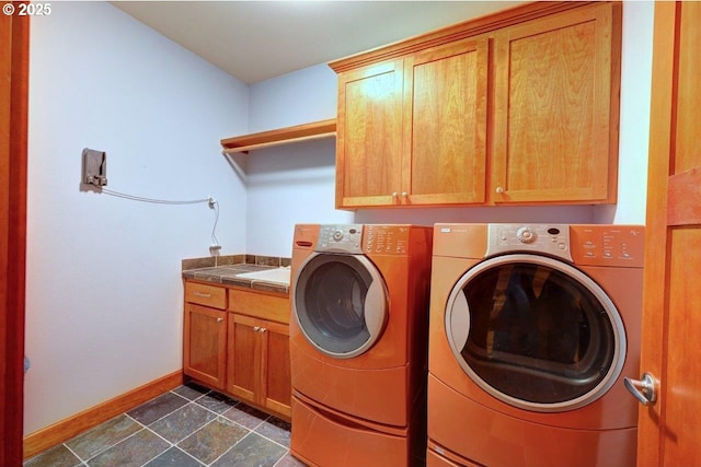 washroom featuring cabinets and independent washer and dryer