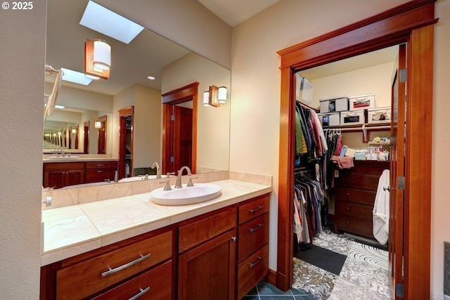 bathroom with a skylight and vanity