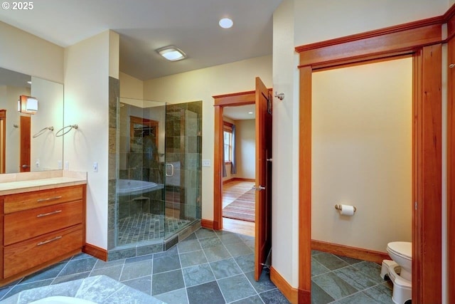 bathroom with toilet, an enclosed shower, and vanity