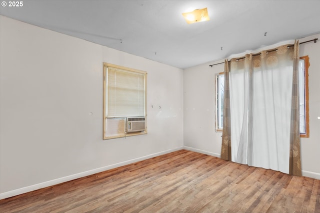 unfurnished room featuring wood finished floors and baseboards