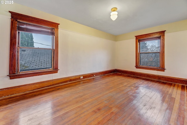 empty room featuring hardwood / wood-style flooring and a healthy amount of sunlight