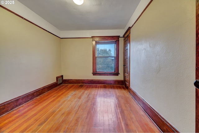 spare room with wood-type flooring