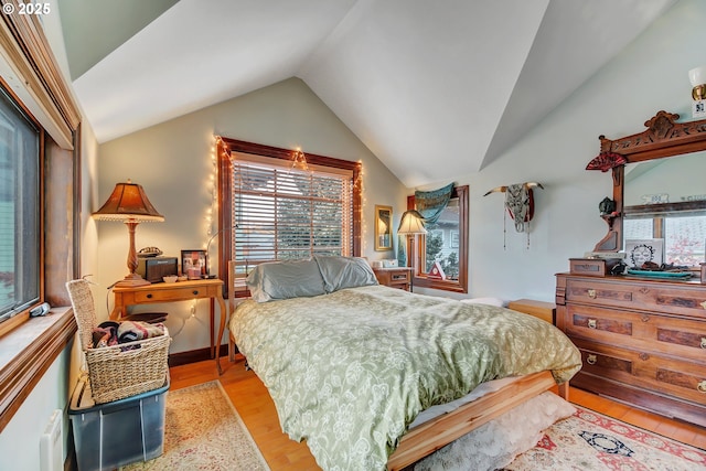 bedroom featuring light hardwood / wood-style flooring and lofted ceiling